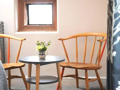 a table and chairs in a room with a window at 1692 Wasdale in Gosforth