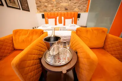a room with two chairs and a table with a bed at 1692 Wasdale in Gosforth
