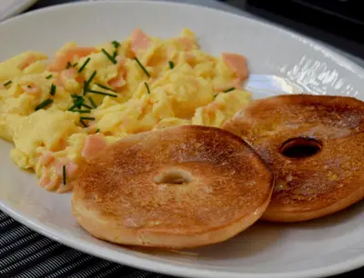 a plate of breakfast food with bagels and scrambled eggs at 1692 Wasdale in Gosforth