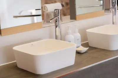 a bathroom with a white sink and a mirror at 1692 Wasdale in Gosforth