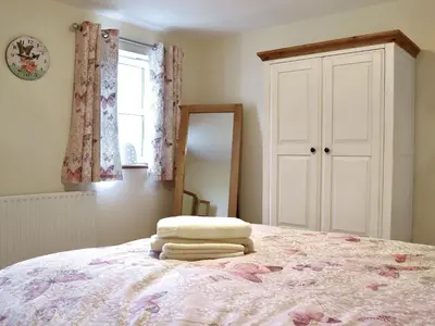 a bedroom with a bed with towels on it at The Costins in Allonby