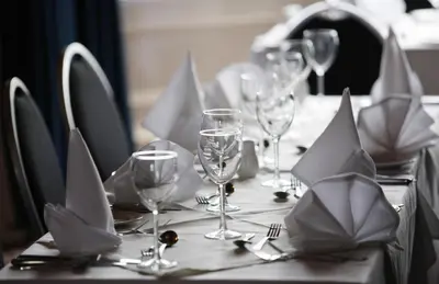 a table with wine glasses and napkins on it at Cressfield Country House Hotel in Ecclefechan