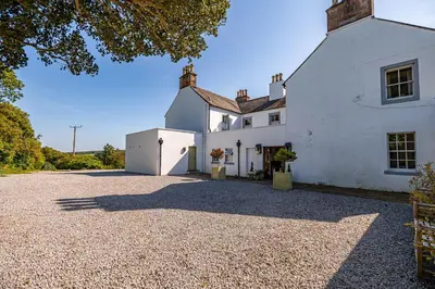 an external view of a white house with a gravel driveway at Cavens Country House, DINNER INCLUSIVE! in Kirkbean