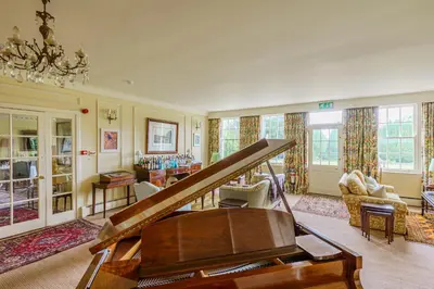 a room with a piano and a living room at Cavens Country House, DINNER INCLUSIVE! in Kirkbean
