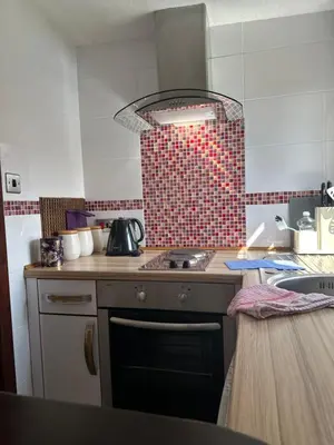 a kitchen with a sink and a stove top oven at Beaches in Ayr