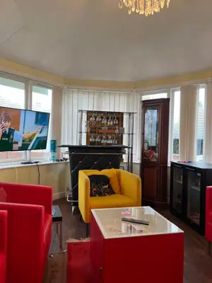 a living room with a yellow couch and a fireplace at Lynebank House Hotel, Bed & Breakfast in Carlisle