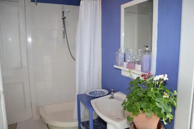 a bathroom with a sink and a toilet and a mirror at Scaurbridge House in Thornhill