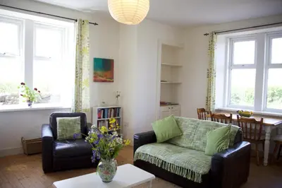 a living room with a couch and chairs and a table at West Lodge in Kirkbean