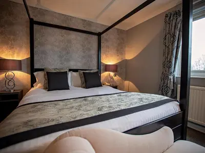 a bedroom with a large bed and two lamps at Sure Hotel by Best Western Lockerbie in Lockerbie
