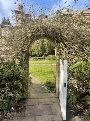 an entrance to a garden with an archway at Dalston Hall in Carlisle