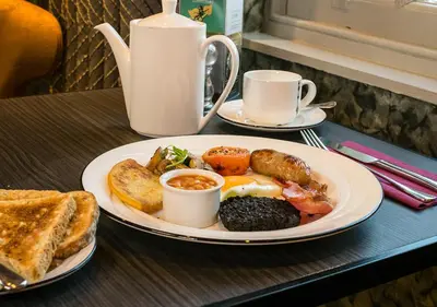 a plate of breakfast food on a table with toast at Hetland Hall Hotel in Dumfries