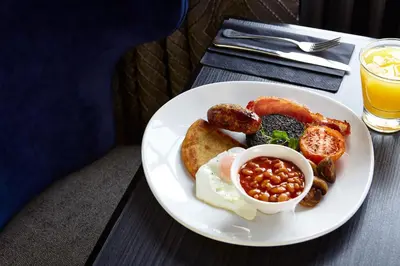 a plate of breakfast food with eggs beans and toast at Hetland Hall Hotel in Dumfries