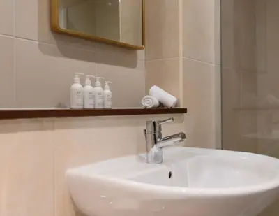a white sink in a bathroom with a mirror at Lyzzick in Keswick