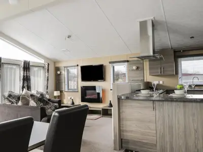 a kitchen and living room with a couch and a counter at Cheri in Mainsriddle