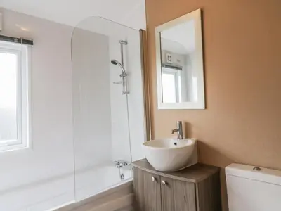 a bathroom with a sink and a shower with a mirror at Cheri in Mainsriddle