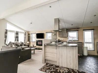 a kitchen and living room with a sink and a couch at Cheri in Mainsriddle