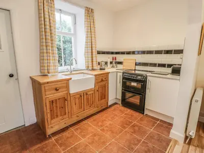a kitchen with a sink and a stove at 27-29 St Marys Place in Kirkcudbright