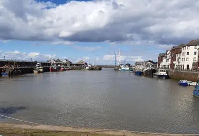 a view of a river with boats in it at Harbour Side in Maryport
