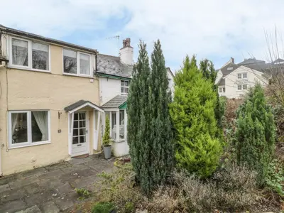 a house with trees in front of it at Derwent Edge in Portinscale
