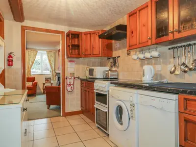 a kitchen with a washer and dryer at Derwent Edge in Portinscale