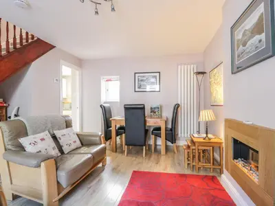 a living room with a couch and a table at Swinside Cottage in Keswick