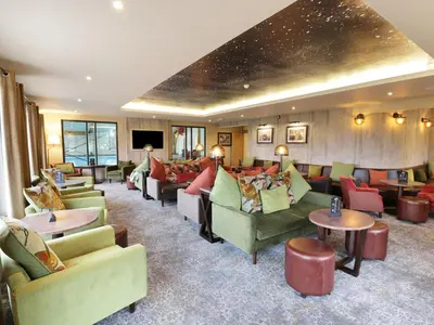a living room with couches and tables in a room at Savita Cottage in Girvan