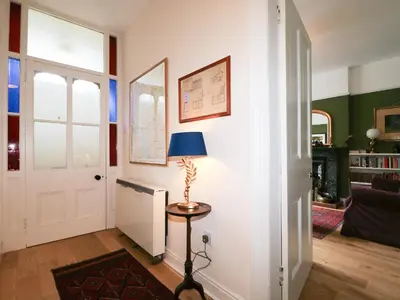 a room with a door and a lamp on a table at Dale House in Cockermouth