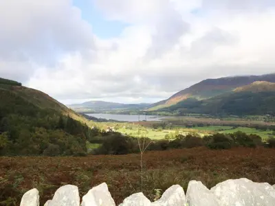 a view of a valley with a lake and mountains at Dale House in Cockermouth