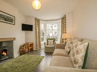 a living room with a couch and a fireplace at Roselea in Keswick