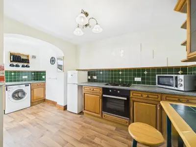 a kitchen with a stove and a dishwasher at Aura in Keswick