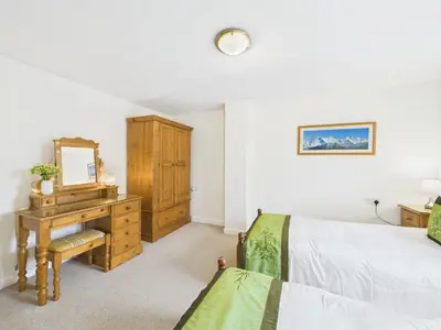 a bedroom with a bed and a desk with a mirror at Aura in Keswick