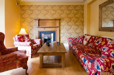 a living room with two couches and a fireplace at Moss Grove Organic in Grasmere