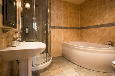 a bathroom with a sink and a shower and a tub at Moss Grove Organic in Grasmere