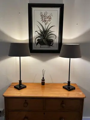 two lamps on a dresser with a picture on the wall at Ravenstone Lodge Country House Hotel in Keswick