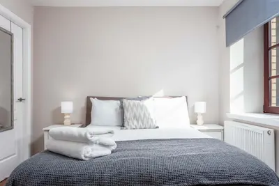 a bedroom with a bed with towels on it at Elliot Suite No2 - Donnini Apartments in Ayr