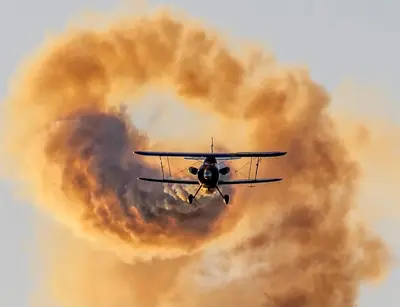 a plane flying in front of a cloud of smoke at No27 Ayr Beach - Coorie Doon Stays in Ayr