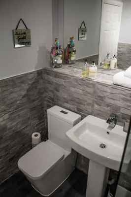 a bathroom with a white toilet and a sink at No27 Ayr Beach - Coorie Doon Stays in Ayr