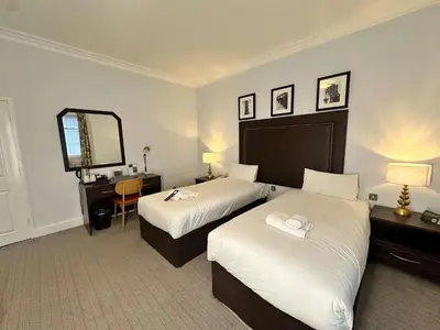 a hotel room with two beds and a mirror at Carlisle Station Hotel, Sure Hotel Collection by BW in Carlisle
