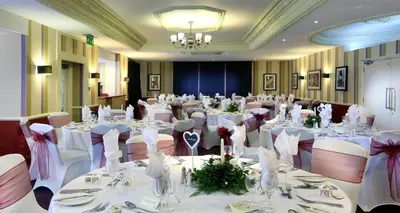 a banquet room with tables with white tablecloths at Carlisle Station Hotel, Sure Hotel Collection by BW in Carlisle