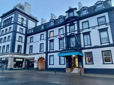 a large white building on a city street at Carlisle Station Hotel, Sure Hotel Collection by BW in Carlisle