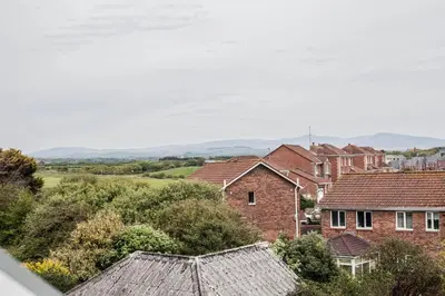 a group of houses in a town with mountains in the background at Keld Green House in Seascale