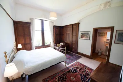 a bedroom with a white bed and a window at Warriston Apartment at Holm Park in Moffat
