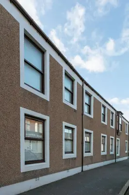 a row of windows on a brick building at Peebles House - Coorie Doon Apartments in Ayr