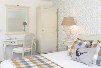 a bedroom with a bed and a desk and a chair at The King's Head in Thirlmere