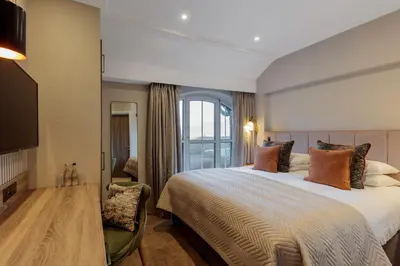 a bedroom with a large bed and a window at The Borrowdale Hotel in Keswick