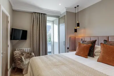 a hotel room with a bed and a tv at The Borrowdale Hotel in Keswick