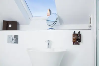 a bathroom with a sink and a mirror and a window at The Annex in Carlisle