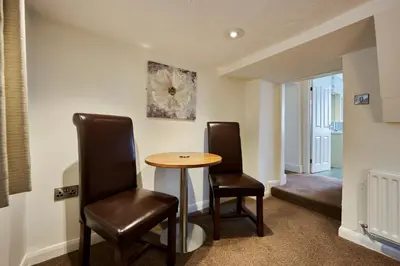 a dining room with two chairs and a table at The Old Ginn House Inn in Great Clifton