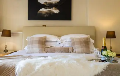 a bedroom with a white bed with pillows at Sella Park Country House Hotel in Seascale