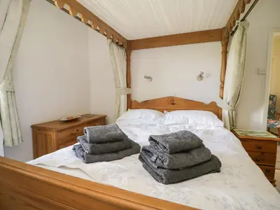 a bedroom with a bed with towels on it at Coombs View in Low Hesket